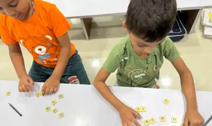 Teacher using creative props for phonics lesson